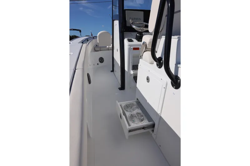Slide: The Image of 2026 Sea Hunt Ultra 275 SE boat interior with storage drawer open. - 18