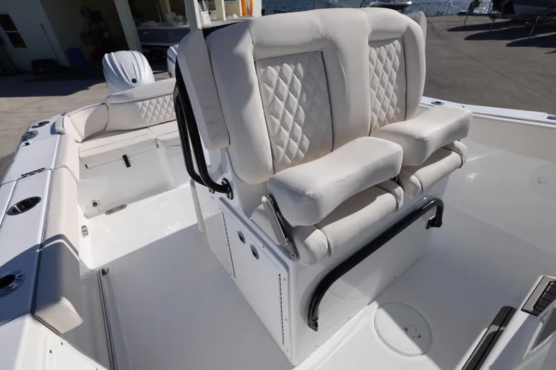 Slide: The Image of Luxurious seating on 2026 Sea Hunt Ultra 275 SE boat, featuring white cushioned seats. - 19