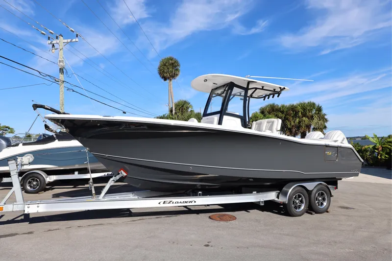 Slide: The Image of 2026 Sea Hunt Ultra 275 SE boat on trailer under clear blue sky. - 26