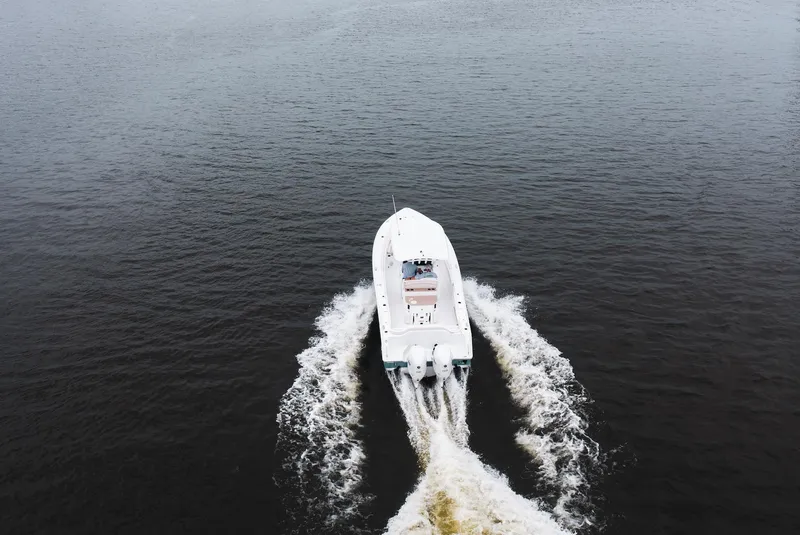 Slide: The Image of Aerial view of 2026 Sea Hunt Ultra 275 SE boat cruising on open water. - 33