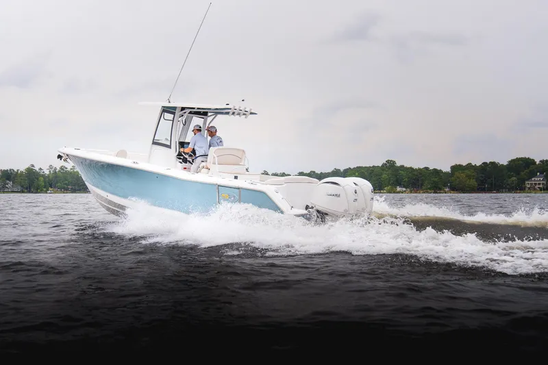 Slide: The Image of 2026 Sea Hunt Ultra 275 SE boat cruising on a lake with two passengers. - 36