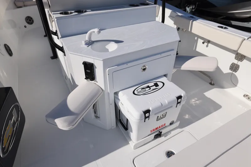 Slide: The Image of 2026 Sea Hunt Ultra 275 SE boat interior with sink, seating, and Yamaha cooler. - 5