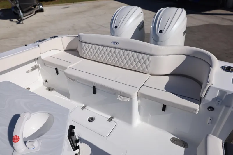 Slide: The Image of 2026 Sea Hunt Ultra 275 SE boat interior with cushioned seating and dual engines. - 6