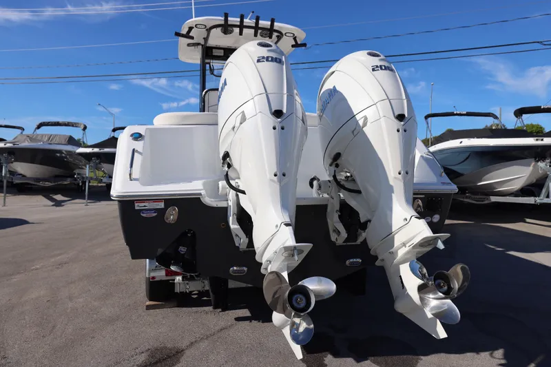 Slide: The Image of 2026 Sea Hunt Ultra 275 SE with dual outboard engines, parked in a marina. - 8