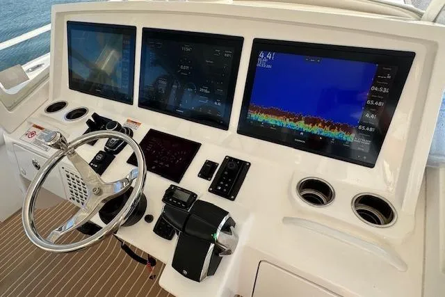 Slide: The Image of Helm of 2016 Intrepid 475 Panacea with advanced navigation displays and controls. - 10