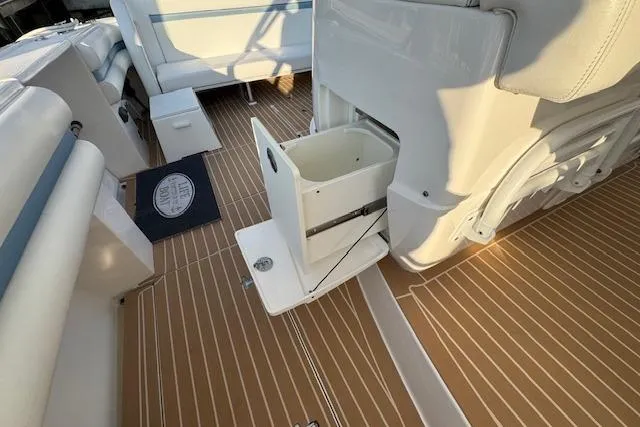 Slide: The Image of 2016 Intrepid 475 Panacea boat interior with open storage compartment on teak deck. - 13
