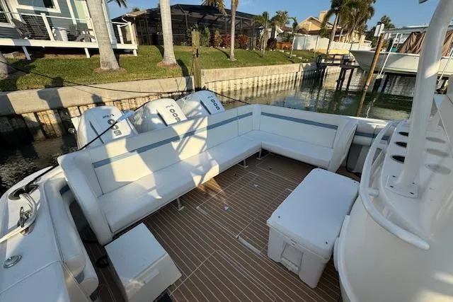 Slide: The Image of 2016 Intrepid 475 Panacea boat with spacious seating and triple outboard engines. - 14