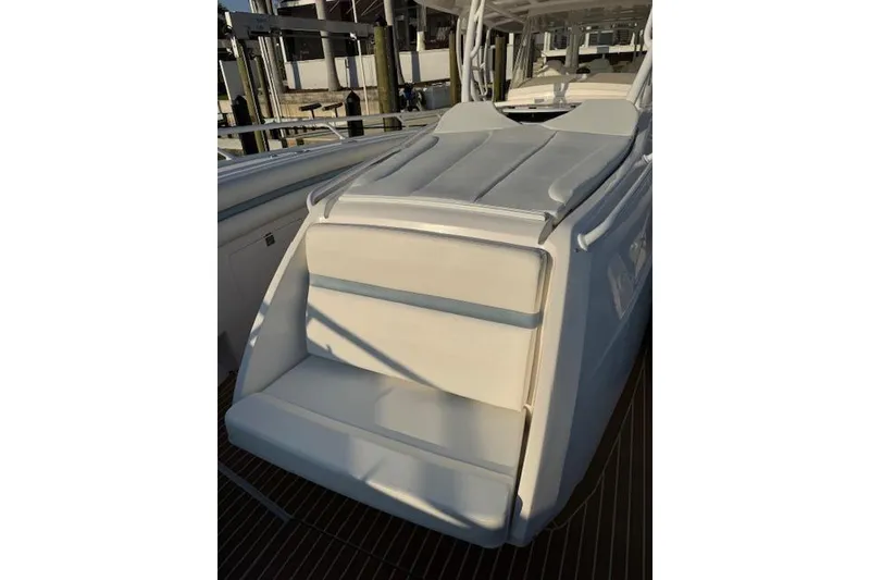 Slide: The Image of 2016 Intrepid 475 Panacea boat with sleek white seating and deck. - 19