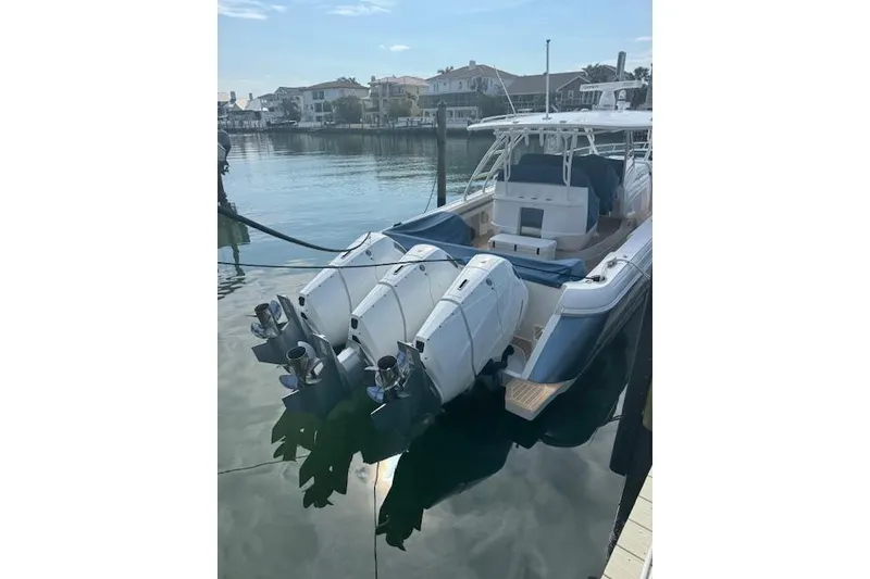 Slide: The Image of 2016 Intrepid 475 Panacea boat docked with triple outboard engines. - 2
