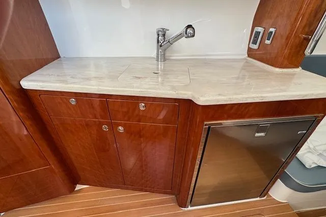 Slide: The Image of Luxurious 2016 Intrepid 475 Panacea yacht interior with wooden cabinetry and modern sink. - 24