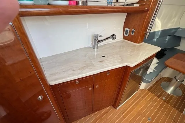 Slide: The Image of 2016 Intrepid 475 Panacea yacht interior with wooden cabinetry and marble countertop. - 25