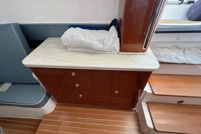 Slide: The Image of Interior of 2016 Intrepid 475 Panacea with wooden cabinetry and seating. - 26