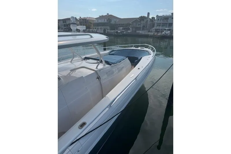 Slide: The Image of 2016 Intrepid 475 Panacea boat docked in a serene waterfront setting. - 3