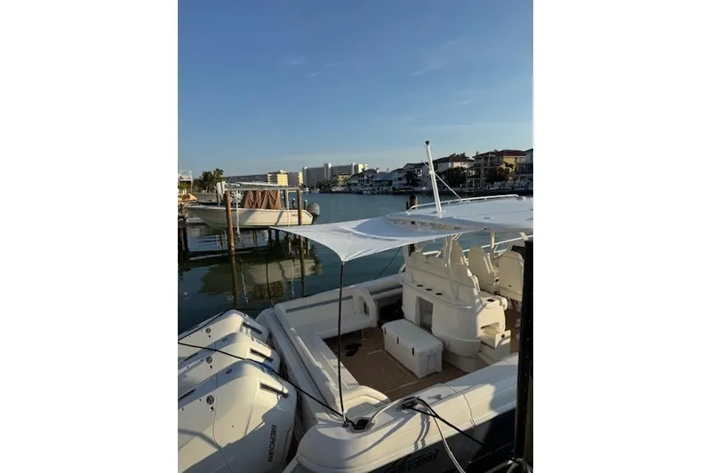 Slide: The Image of 2016 Intrepid 475 Panacea boat docked in a scenic marina setting. - 8