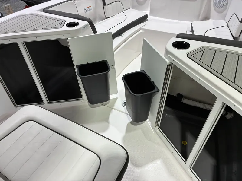 Slide: The Image of Interior of 2026 Yamaha Boats 222 FSH Sport with storage and trash bins. - 13
