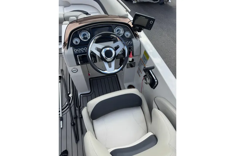 Slide: The Image of 2019 Starcraft Star Step 221 I/O boat cockpit with steering wheel and control panel. - 10