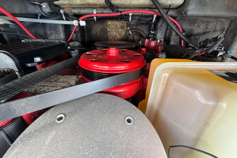 Slide: The Image of Engine compartment of a 2019 Starcraft Star Step 221 I/O boat, featuring red components and belts. - 18