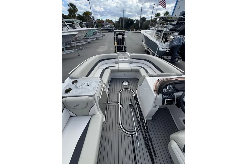 Slide: The Image of 2019 Starcraft Star Step 221 I/O boat interior with seating and dashboard, docked outdoors. - 19