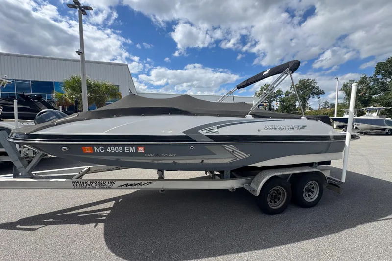 Slide: The Image of 2019 Starcraft Star Step 221 I/O boat on trailer under blue sky. - 6