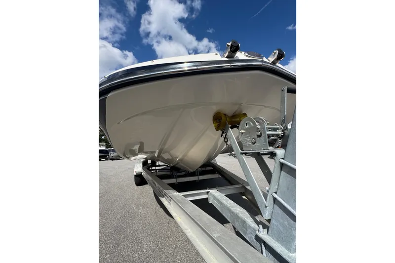 Slide: The Image of 2019 Starcraft Star Step 221 I/O boat on trailer under blue sky. - 9