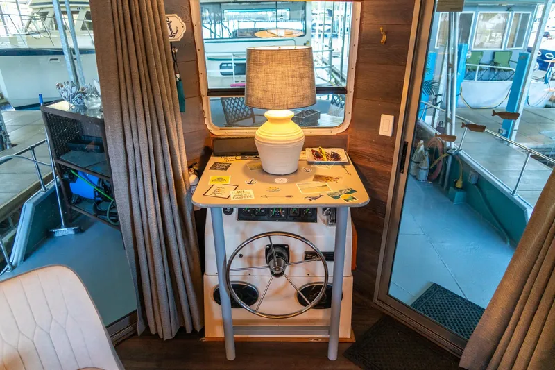 Slide: The Image of Interior of 1989 Seabreeze houseboat with helm, lamp, and nautical decor. - 10