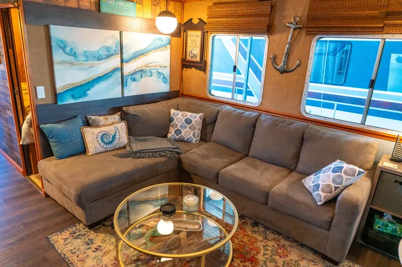 Slide: The Image of Cozy living area in 1989 Seabreeze houseboat with sectional sofa and nautical decor. - 11