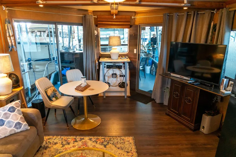 Slide: The Image of Interior of 1989 Seabreeze 53 x 14 houseboat with cozy living area and modern decor. - 12