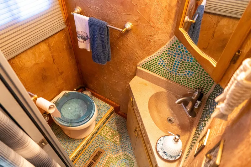 Slide: The Image of Compact bathroom in 1989 Seabreeze houseboat with mosaic tiles and modern fixtures. - 17