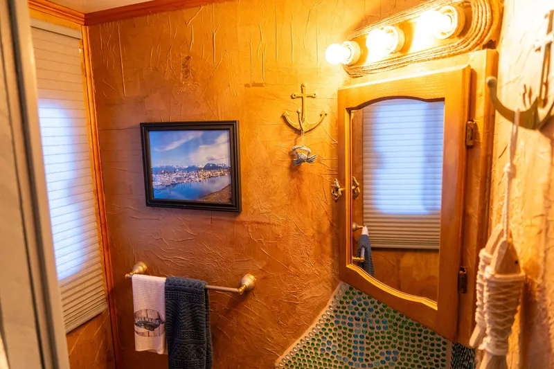 Slide: The Image of Cozy 1989 Seabreeze houseboat bathroom with nautical decor and warm lighting. - 18