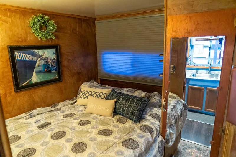 Slide: The Image of Cozy bedroom in 1989 Seabreeze houseboat with decorative pillows and wall art. - 19