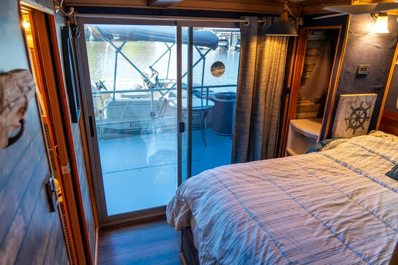 Slide: The Image of Cozy bedroom in 1989 Seabreeze houseboat with waterfront view and nautical decor. - 23