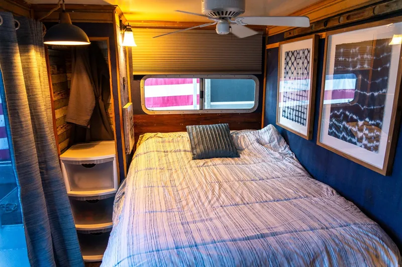Slide: The Image of Cozy bedroom in 1989 Seabreeze houseboat with striped bedding and framed artwork. - 24