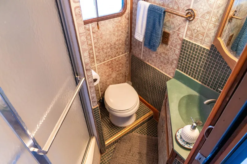 Slide: The Image of Compact bathroom in 1989 Seabreeze houseboat with shower, toilet, and sink. - 25