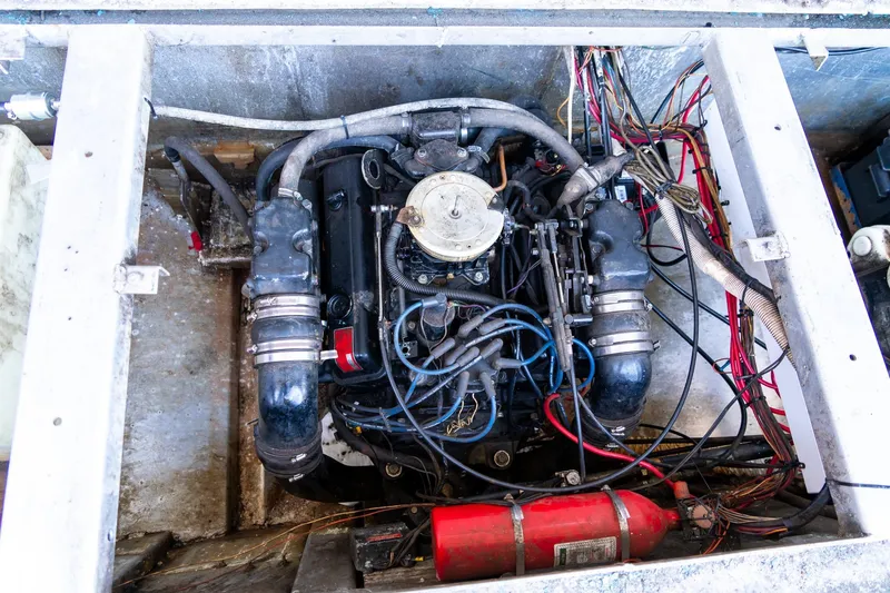 Slide: The Image of Engine compartment of a 1989 Seabreeze 53 x 14 houseboat with visible wiring and fire extinguisher. - 28