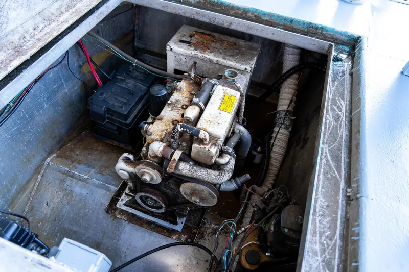 Slide: The Image of Engine compartment of a 1989 Seabreeze 53 x 14 houseboat, showing mechanical components. - 30