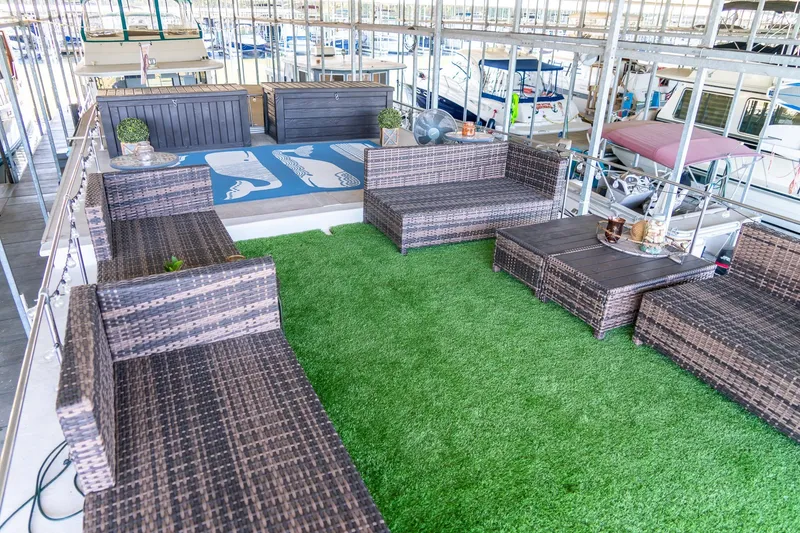 Slide: The Image of Outdoor seating area on 1989 Seabreeze 53 x 14 houseboat with artificial grass and wicker furniture. - 32