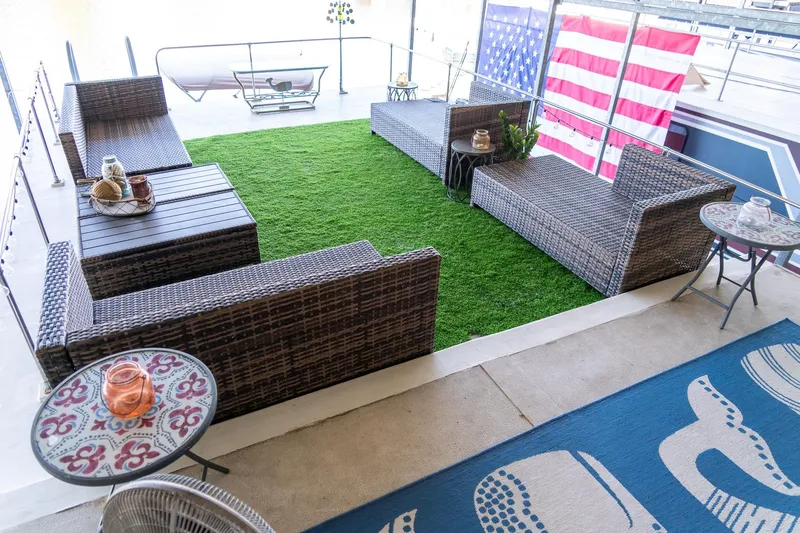 Slide: The Image of Outdoor seating area on 1989 Seabreeze houseboat with artificial grass and American flag. - 37