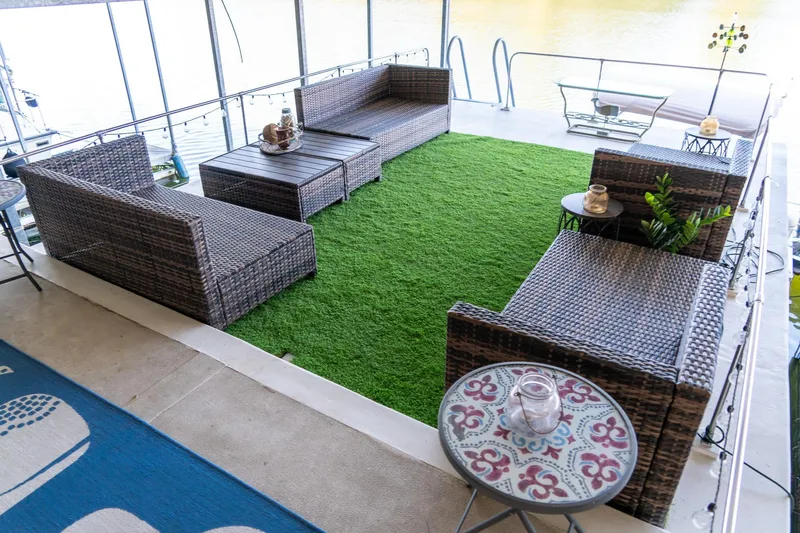Slide: The Image of Outdoor seating area on 1989 Seabreeze 53 x 14 houseboat with artificial grass and wicker furniture. - 38
