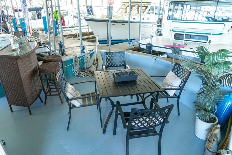 Slide: The Image of Outdoor seating area on 1989 Seabreeze 53 x 14 houseboat with table, chairs, and bar stools. - 7