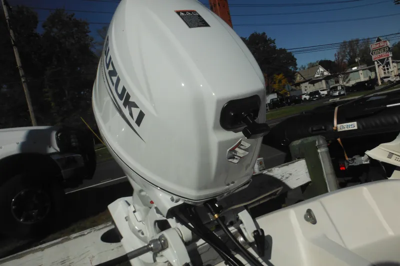 Slide: The Image of 1973 Boston Whaler 13 Sport Side with Suzuki outboard motor. - 10