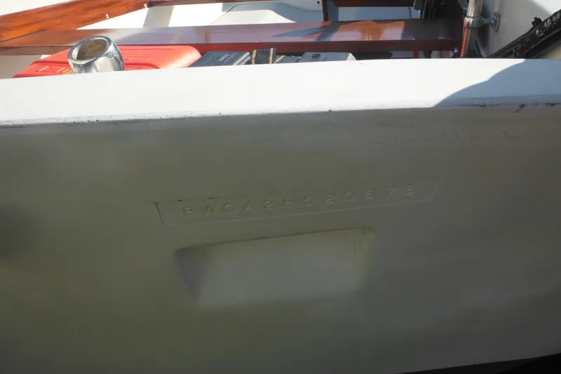 Slide: The Image of 1973 Boston Whaler 13 Sport Side boat hull with visible serial number. - 11