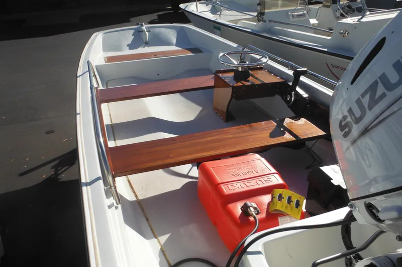 Slide: The Image of 1973 Boston Whaler 13 Sport Side boat with Suzuki engine and wooden seats. - 4