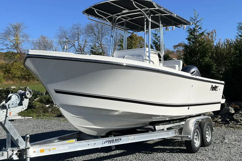 The Image of 2026 Parker 210 Coastal boat on trailer, outdoors, under clear sky. - 1