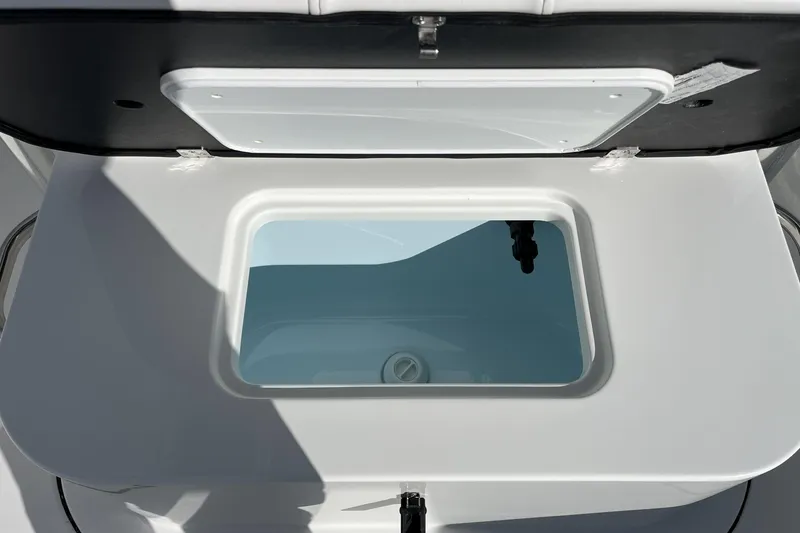 Slide: The Image of Open storage compartment on 2026 Parker 210 Coastal boat, showcasing interior design. - 10