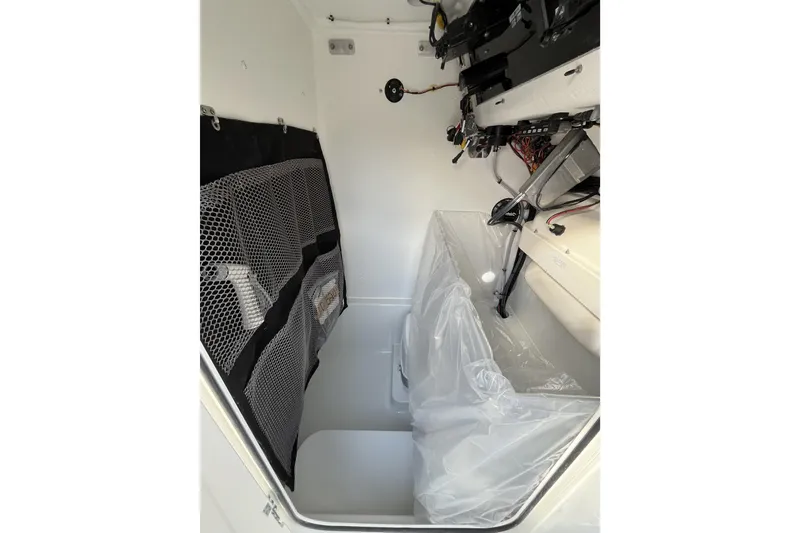 Slide: The Image of Interior of 2026 Parker 210 Coastal boat with storage and wiring. - 11