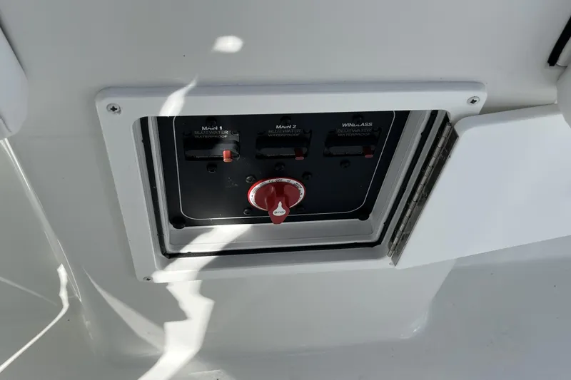 Slide: The Image of Control panel on a 2026 Parker 210 Coastal boat, featuring switches and a red dial. - 6