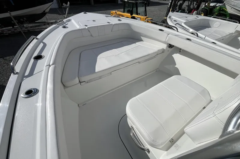 Slide: The Image of 2026 Parker 210 Coastal boat interior with white seating and stainless steel fixtures. - 7