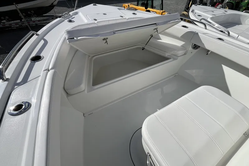 Slide: The Image of 2026 Parker 210 Coastal boat interior with open storage compartment and seating. - 8