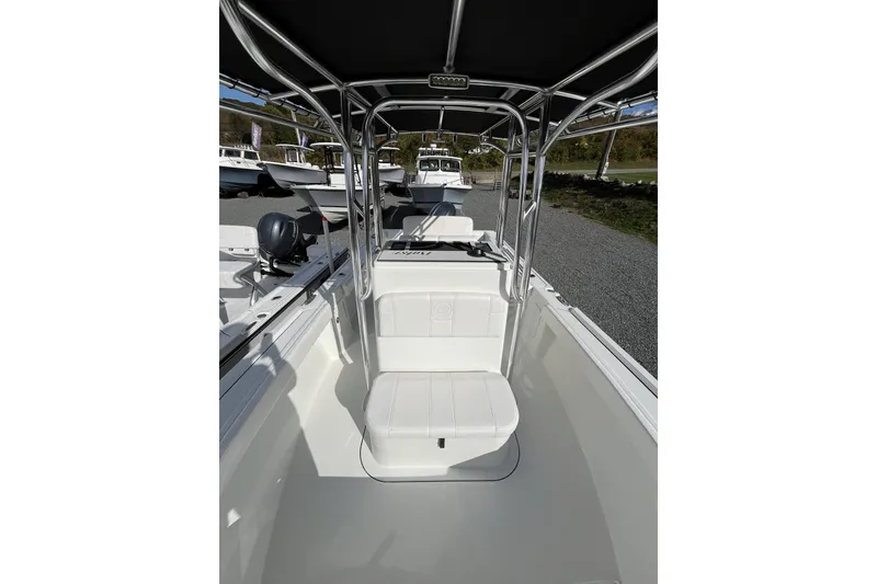 Slide: The Image of 2026 Parker 210 Coastal boat interior with seating and canopy, displayed outdoors. - 9