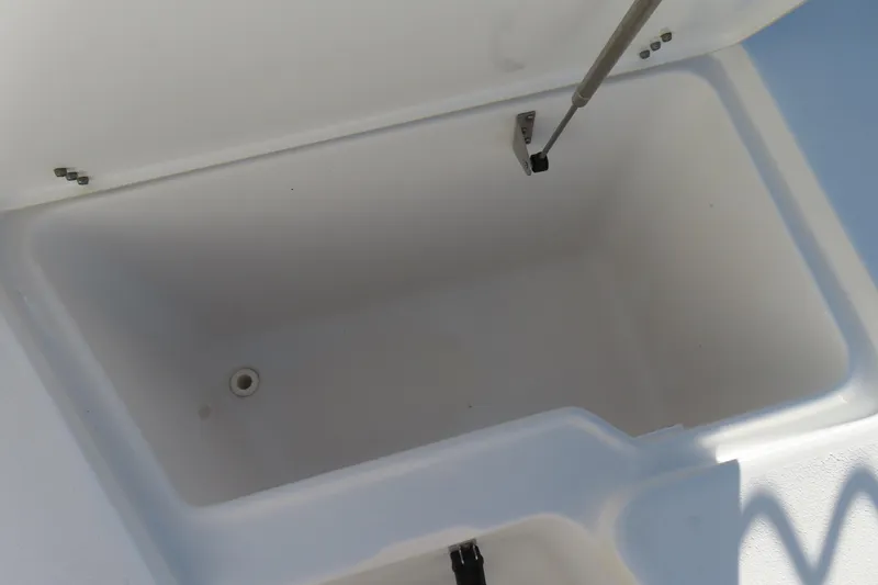 Slide: The Image of Open storage compartment on 2018 Sea Hunt Ultra 234 boat. - 10